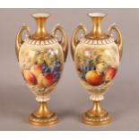 A PAIR OF ROYAL WORCESTER FRUIT PAINTED TWO HANDLED VASES, signed Ricketts, the ovoid body painted