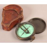 A LATE 19TH/EARLY 20TH CENTURY BRONZE PRISMATIC SURVEYING COMPASS, the 7.5cm green paper dial