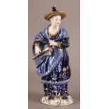 A DRESDEN CHINA FIGURE OF A MUSICIAN, blue glaze and gilt wearing a broad brimmed hat, flowing robes