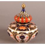 A ROYAL CROWN DERBY COMPRESSED LOBED JAR AND COVER, pattern 1128, sexafoil body, the cover pierced