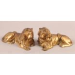 A PAIR OF 19TH CENTURY ORMOLU FIGURES OF RECUMBENT LIONS, realistically modelled, 13cm long approx