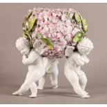 A VICTORIAN CHINA VASE of spherical shape, all over encrusted with pink-veined white petals and leaf