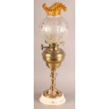 AN ARTS AND CRAFTS BRASS OIL LAMP, having a brass reservoir embossed with scrollwork, opaque