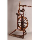 A LATE 18TH/EARLY 19TH CENTURY FRUITWOOD SPINNING WHEEL of conventional form, 30cm diameter wheel