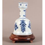 A CHINESE PORCELAIN BELL SHAPED VASE with unglazed shallow foot, cylindrical neck and rim, decorated