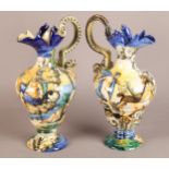 A PAIR OF LATE 19TH CENTURY CANTAGALLI FAIENCE POTTERY EWERS, the inverted pear shaped bodies