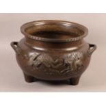 A JAPANESE BRONZE TWO HANDLED LARGE CENSER, cast in relief with turtle, dragon, longma and