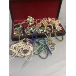 A collection of costume jewellery including necklaces, brooches, bracelets and bangles, each in a