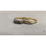 A George V three stone diamond ring in 18ct gold, the graduated brilliant cut stones claw set in