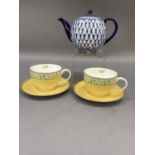 A pair of Halycon Days cups and saucers for Castle Mey and a Russian China blue white and guilt
