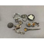 A collection of silver jewellery including an Art Nouveau brooch by Charles Horner set with a purple