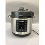 A Crock-Pot slow cooker with manual, as new