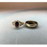 A gentleman's garnet set ring in 9ct gold; together with a 9ct gold wedding ring, total