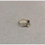 An Edward VII sapphire, diamond and pearl ring in 18ct gold, the pear shaped faceted sapphire and