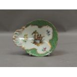 A 20th century Meissen trinket dish painted to the centre with a romantic couple, within floral