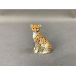 A Royal Crown Derby paperweight cheetah cub with gold button to underside