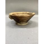 A turned wooden bowl with rudimentary handle, 23cm by 10cm