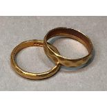 Two wedding rings in 22ct gold, total approximate weight 6.1gm.