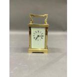 A brass cased carriage clock, retailed by Dyson and Sons London, 15cm over handle