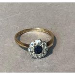 A George V sapphire and diamond cluster ring in 18ct yellow and white gold, set to the centre with