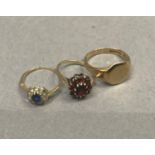 Three rings, all in 9ct gold, two cluster dress rings variously set with garnet, blue and colourless