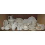 A collection of white dinner ware including meat plates, tureen stand, dinner, dessert and side