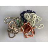 A collection of early to mid 20th bead necklaces including a simulated coral and cultured pearl
