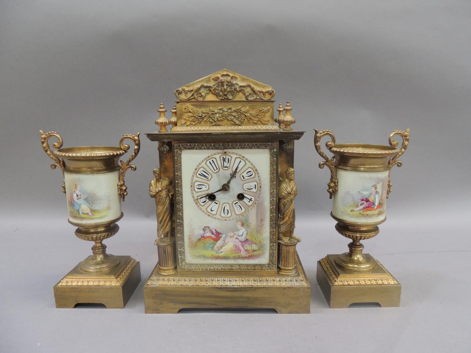 A French gilded brass and porcelain clock garniture, the clock of architectural design with face