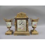 A French gilded brass and porcelain clock garniture, the clock of architectural design with face