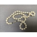 A cultured pearl necklace, the approximately 6mm pearls fastened with a pearl set 9ct gold white