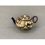 A Royal Crown Derby miniature teapot, 5.5cm high
