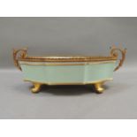 A Limoges china and gilt metal dish having twin leaf capped scroll handles, the quatrefoil shaped