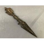 A cast metal temple dagger, the hilt with triple mask and animal's head pommel, 28.5cm long