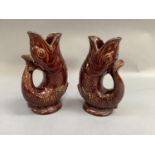 A pair of Dartmouth Pottery fish vases of brown glaze, 23.5cm high