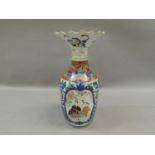 A late 19th century Japanese vase, having a flared and frilled rim, above a shouldered ovoid body,