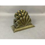 A late Victorian brass scallop shaped letter rack of two divisions on a stepped rectangular base,