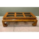 A reproduction stained elm coffee table matching the preceding lot, inset four bevelled smoked glass