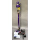 A Dyson model V10-UK with instruction manual