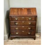A reproduction mahogany bureau in George III style, cross banded, the flap revealing