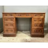 A Victorian mahogany twin pedestal desk of inverted break front form, the top with moulded lip above