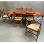 A reproduction mahogany Regency style oval dining table, the top on pair of turned supports, each