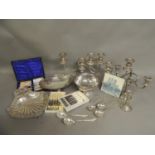 A quantity of silver plated ware including a pair of two branch candelabrum, another, a pedestal