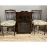 A pair of Victorian rail back salon chairs with stuffed over seats on fluted, turned tapered legs,