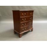 A reproduction mahogany serpentine chest in George III style, fitted with four cockbeaded drawers,