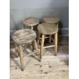 A set of four beech stools with circular tops, turns legs joined by stretchers