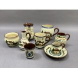 A collection of motto ware including vinegar bottle, mug, jugs in various sizes, sugar bowl, etc.