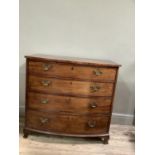 A Regency mahogany bow front chest of drawers, the figured top with boxwood strung edge above four