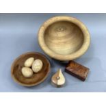 Two yew wood treen turned bowls, various treen eggs, trinket boxes and a turned bowl stamped Bon