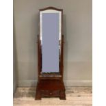 A reproduction mahogany cheval mirror, serpentine bevel plate within plain frame on turned