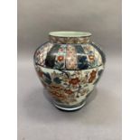 A 19th century baluster vase decorated in Imari pallet with flowers and leafage beneath formal